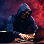 hacker man typing on laptop