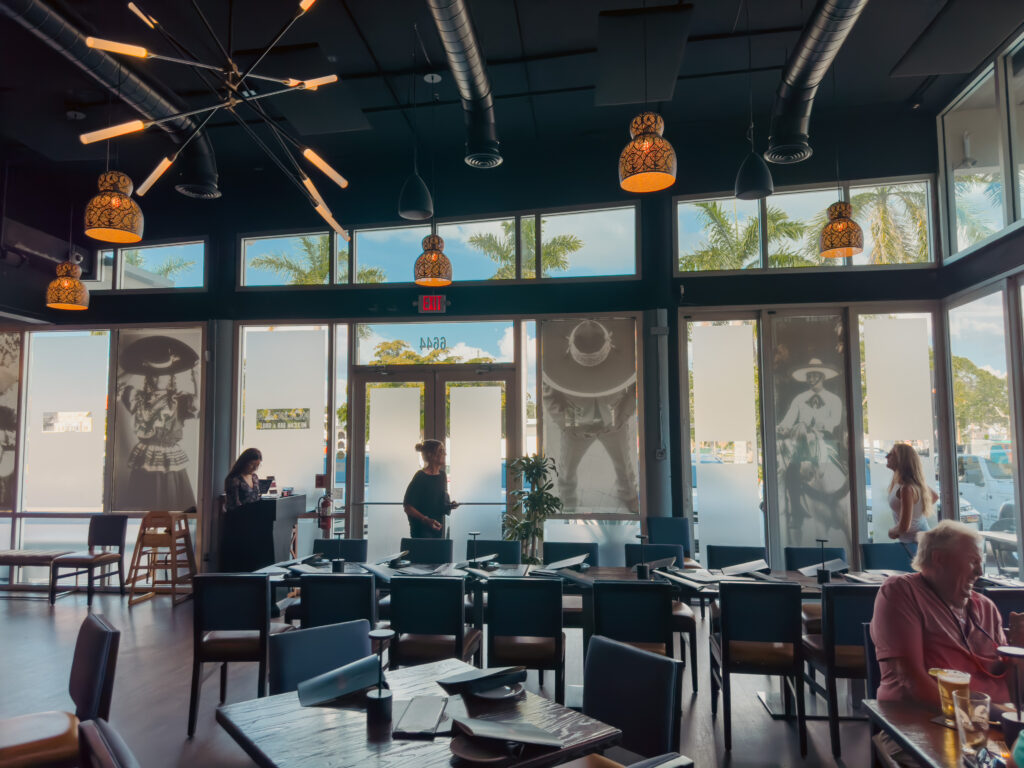 Kolucan Mexican Bar & Grill - Sunlit dining room, pendant lamps, tall front windows