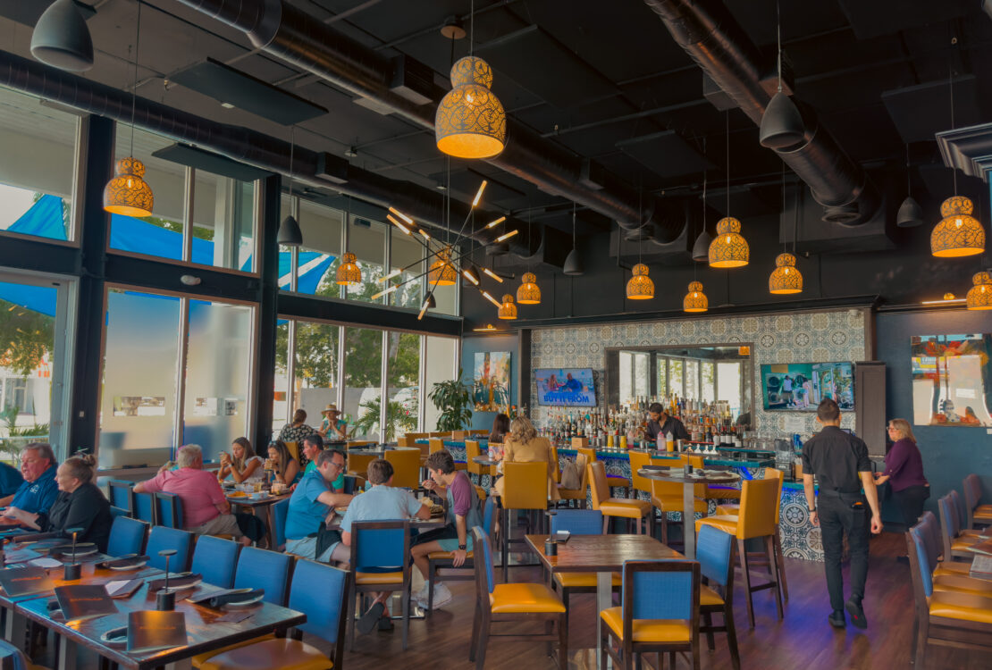 Kolucan Mexican Bar & Grill - Dining room and bar at Kolucan Mexican Bar & Grill in Sarasota with mustard-yellow chairs and patterned tilework