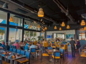 Kolucan Mexican Bar & Grill - Dining room and bar at Kolucan Mexican Bar & Grill in Sarasota with mustard-yellow chairs and patterned tilework