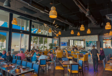 Kolucan Mexican Bar & Grill - Dining room and bar at Kolucan Mexican Bar & Grill in Sarasota with mustard-yellow chairs and patterned tilework
