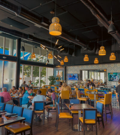 Kolucan Mexican Bar & Grill - Dining room and bar at Kolucan Mexican Bar & Grill in Sarasota with mustard-yellow chairs and patterned tilework
