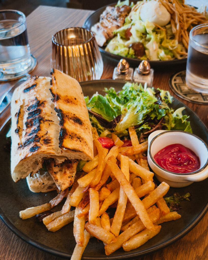Allswell - Waterside Place Review 81 Southern chicken sandwich on grilled bread at Allswell with hand cut fries, ketchup, and a side salad