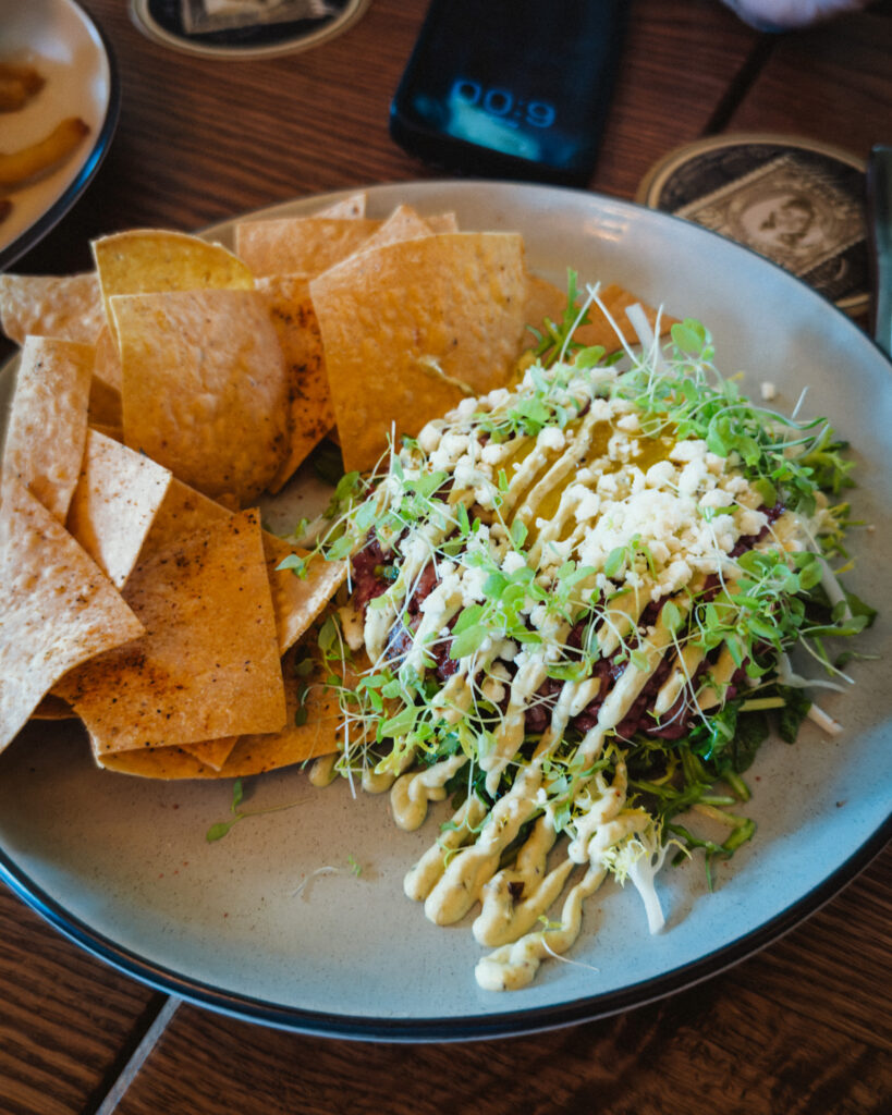 Allswell - Waterside Place Review 78 Carne asada tartar at Allswell with salted yolk, frisรฉe, cotija, poblano aioli, and seasoned tortilla crisps
