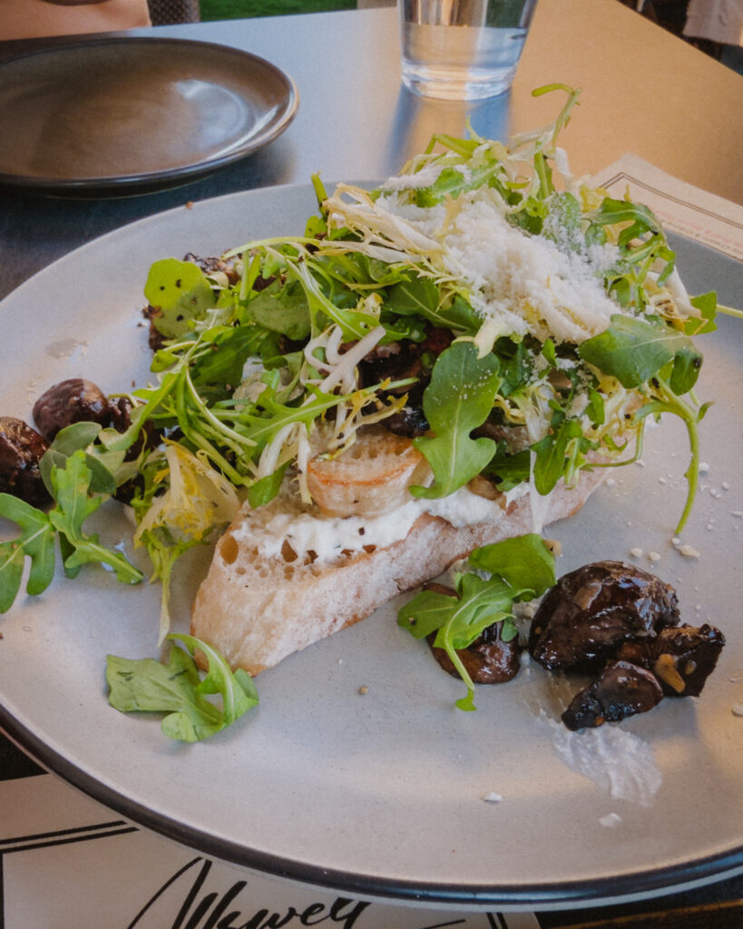 Allswell - Waterside Place Review 79 Wild mushroom toast at Allswell with ricotta, arugula, shaved cheese, and roasted mushrooms on grilled crostini