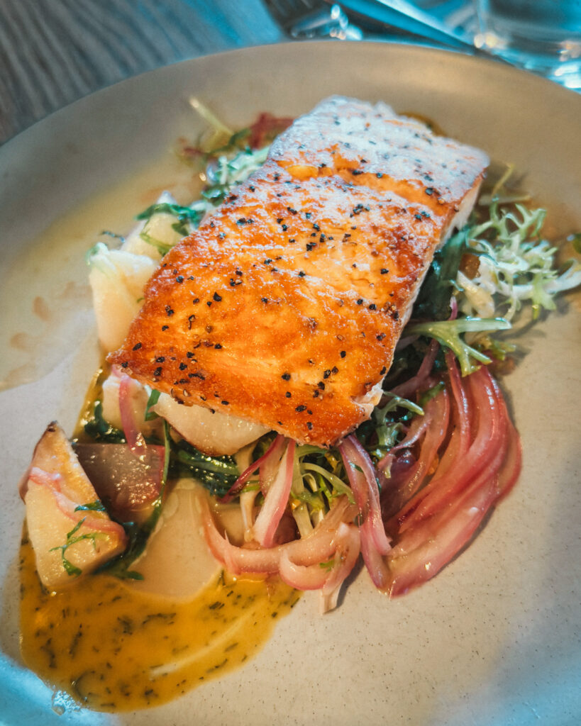 Allswell - Waterside Place Review 82 Pan seared Scottish salmon at Allswell with pickled red onion, roast potatoes, greens, and mustard dill sauce