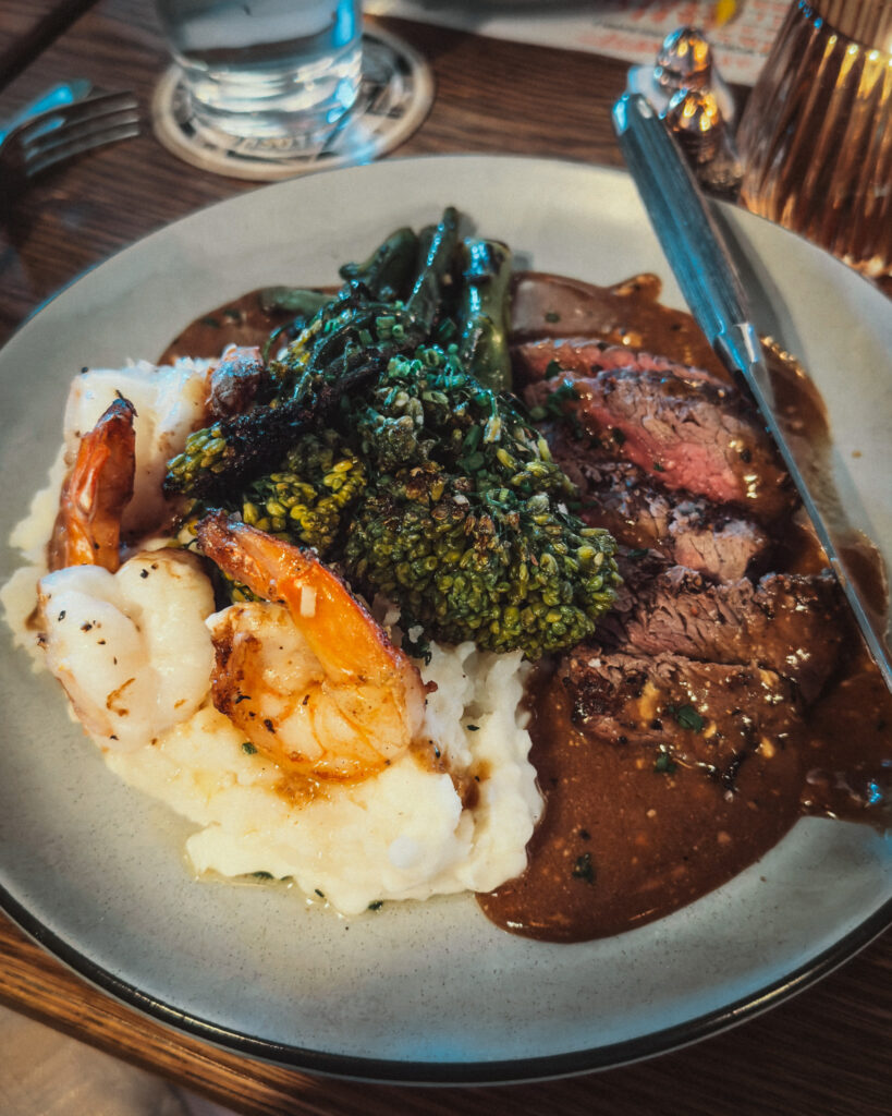 Allswell - Waterside Place Review 84 Surf and turf special at Allswell in Lakewood Ranch with sliced filet, grilled shrimp, mashed potatoes, and broccolini in pan gravy